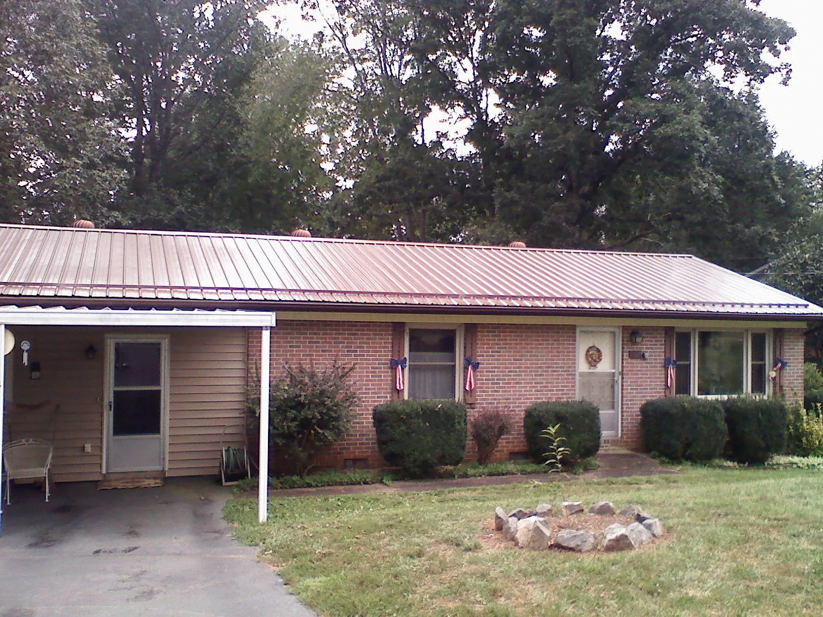 Bronze metal roof and carport on a brick ranch home — Roof Repair work by our crew in Rancho Cordova