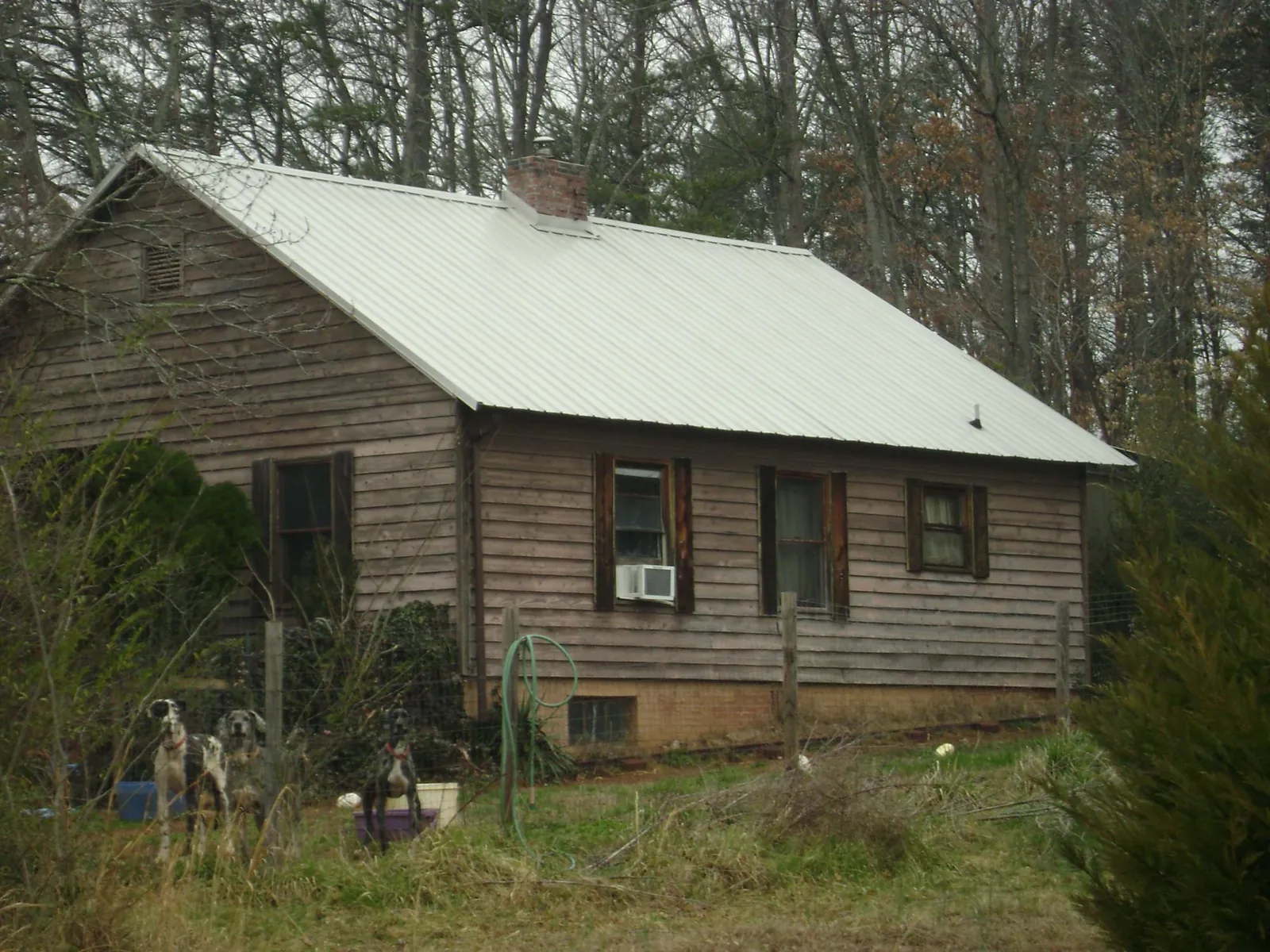 White metal roof on an old wood sided farmhouse, from a Metal Roof Installation job in Rancho Cordova